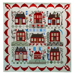 Red and white quilt with 9 different style homes in a grid